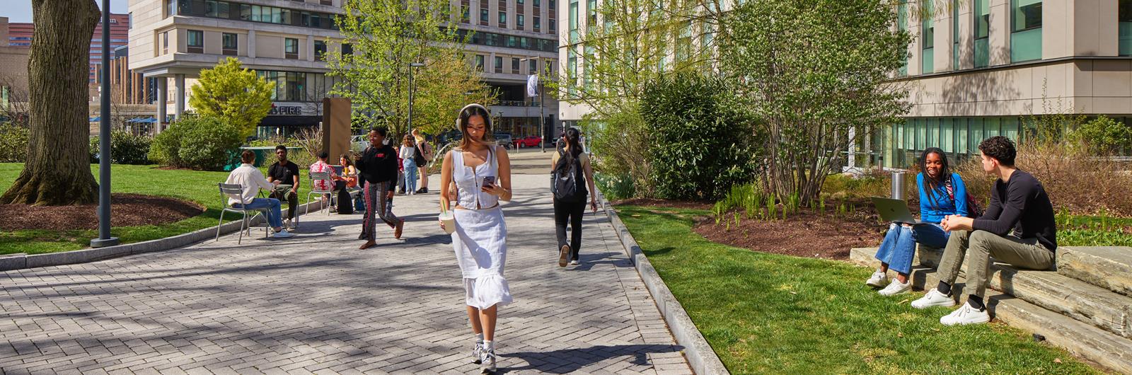 Person wearing headphones walking on Korman woodland walk