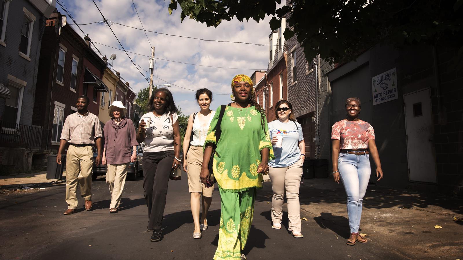 drexel and community side-by-side students walk down a street together 