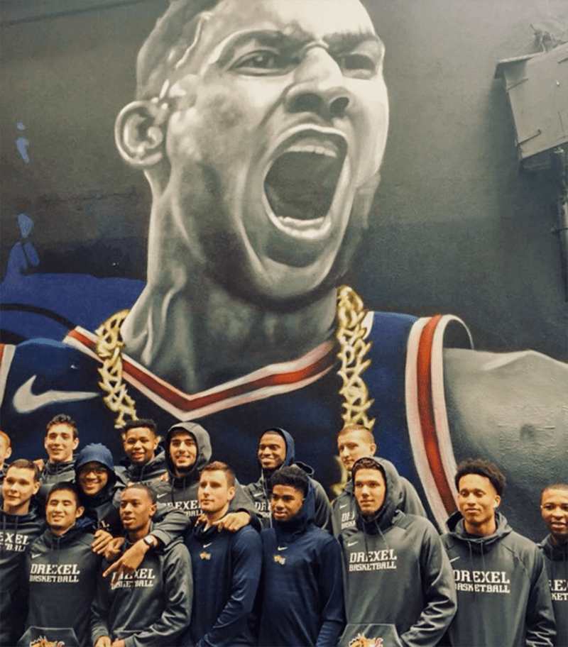 Drexel’s men’s basketball team in front of a mural of Ben Simmons in Melbourne, Australia.