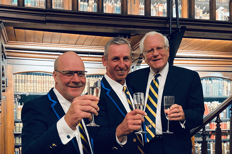 Go Dragons — a toast to 2020! From left: Athletics Director Eric Zillmer, Director of Rowing Paul Savell and Trustee Emeritus and Drexel alumnus George Krall.