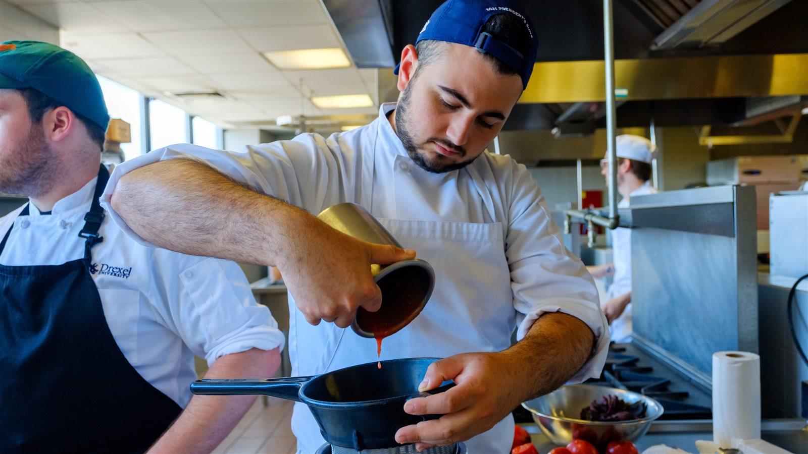 Zac Cohen cooks a trial dish.
