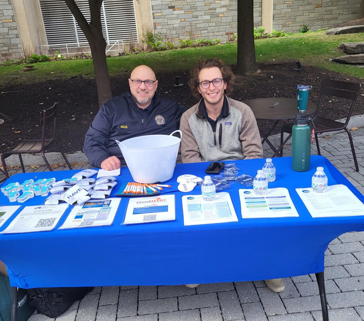 Clery Compliance Officer Aden Betman (right) posing with Director of Clery Compliance Moe DeLisi (left) at last month’s Public Safety Fair.]