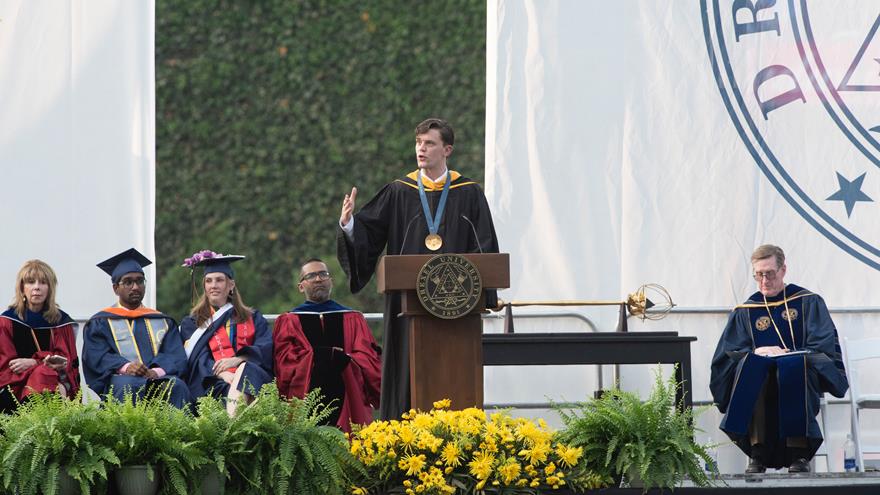 Justin Best at the podium at Drexel's Commencement