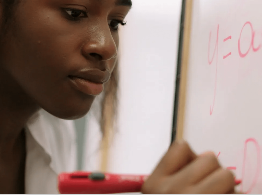 Woman working at whiteboard