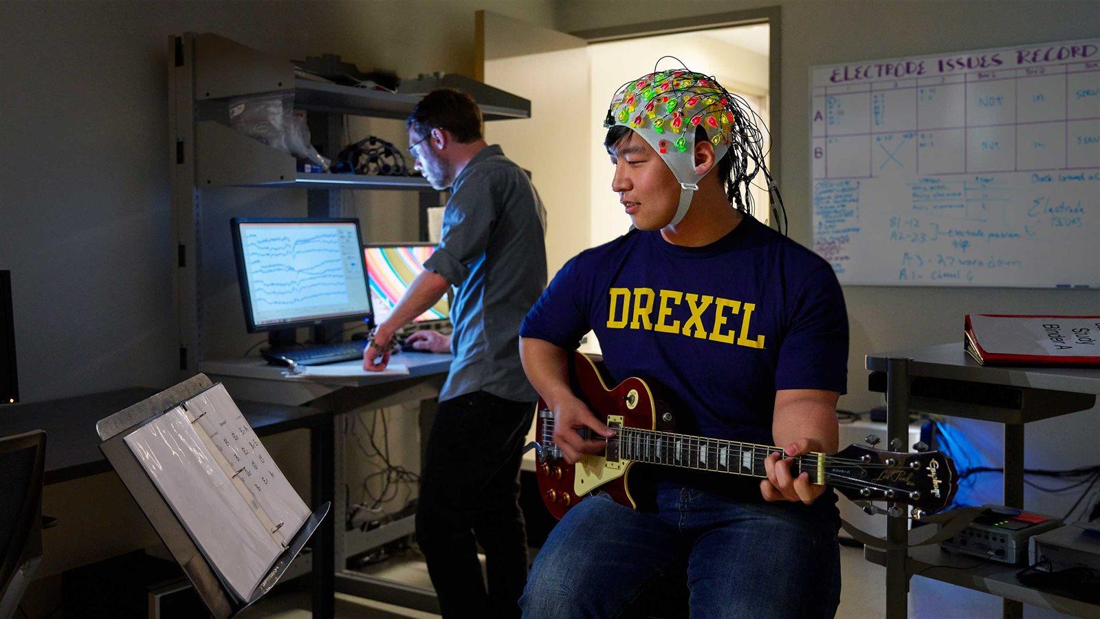 Psychology students working with brain mapping equipment