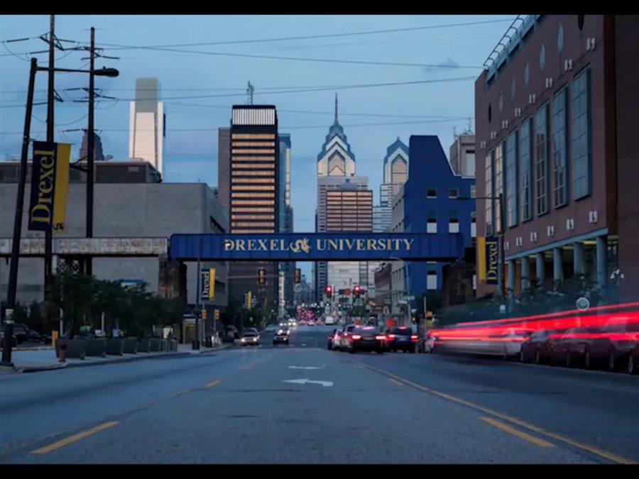 Philadelphia skyline with &#39;Drexel University&#39; painted on a rail bridge in the foreground.